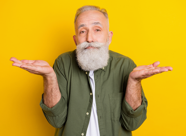 older guy with white beard shrugging.