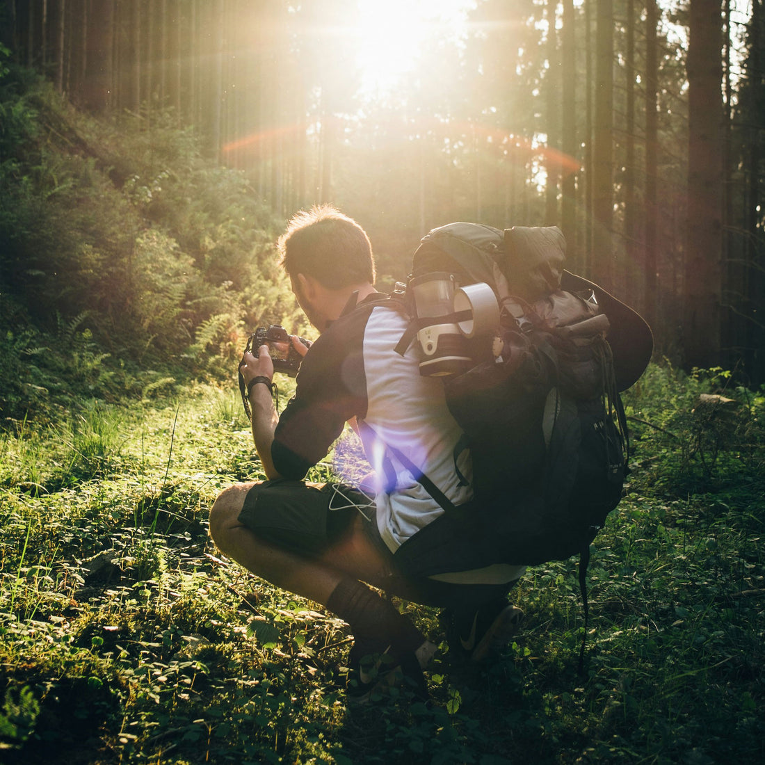 Man wearing a backpack in the woods.