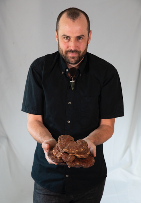 Hamilton holding mushrooms.