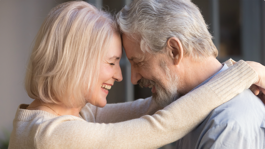 older couple hugging.