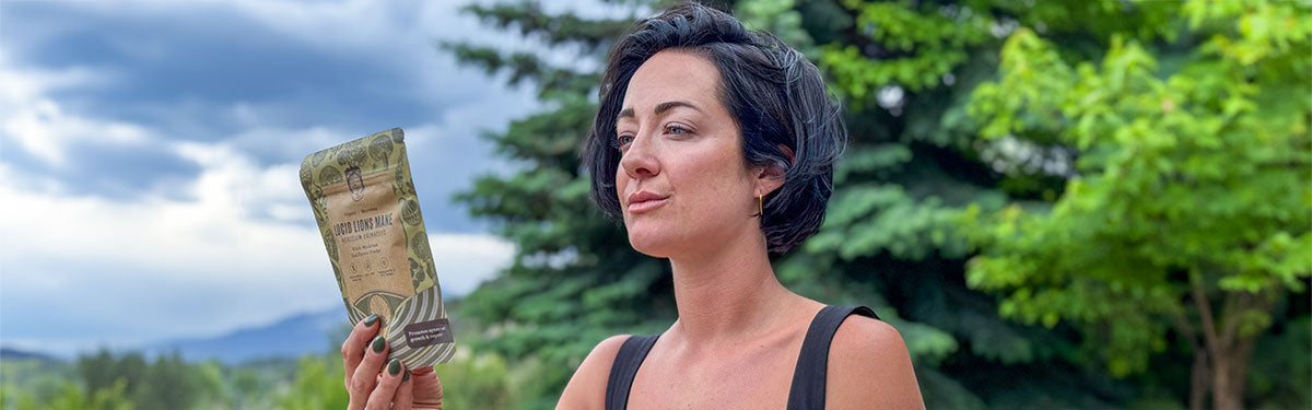 A woman holding Hamilton's Lucid Lion's Mane Mushroom Extract